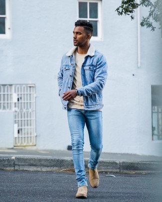 Shearling Jacket Outfits For Men: This combination of a shearling jacket and light blue skinny jeans is on the off-duty side but guarantees that you look dapper and truly stylish. Go ahead and complement your ensemble with tan suede chelsea boots for a sense of sophistication.