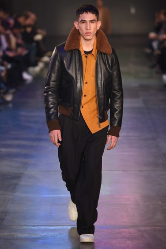 Black Shearling Jacket Outfits For Men: This combination of a black shearling jacket and black chinos is proof that a simple casual ensemble can still look incredibly stylish. For something more on the daring side to complete this getup, introduce a pair of white leather low top sneakers to your outfit.