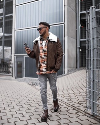 500+ Winter Outfits For Men: This outfit with a dark brown shearling jacket and grey ripped skinny jeans isn't a hard one to score and leaves room to more creative experimentation. Dark brown leather chelsea boots will infuse a hint of polish into an otherwise everyday look. During the colder months, when practicality is everything, it can be easy to settle for a less-than-stylish getup in the name of practicality. But this getup is a vivid example that you can actually stay comfy and remain stylish at the same time during the colder months.