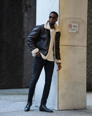 500+ Winter Outfits For Men: You'll be amazed at how extremely easy it is for any man to pull together this off-duty ensemble. Just a black shearling jacket combined with navy skinny jeans. Boost the classiness of your outfit a bit by rocking black embellished leather chelsea boots. A practical illustration of comfortable fashion, this ensemble must be in your front hall closet this winter season.