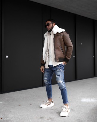 500+ Winter Outfits For Men: If you're a fan of urban combos, then you'll love this pairing of a brown shearling jacket and blue ripped skinny jeans. A pair of beige athletic shoes will be the perfect addition for your ensemble. This ensemble is equally stylish and warm. Double win!