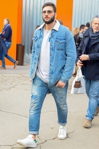 Shearling Jacket Outfits For Men: We're all on the lookout for comfort when it comes to fashion, and this urban combination of a shearling jacket and light blue ripped jeans is a vivid example of that. White leather low top sneakers are a stylish addition for your getup.