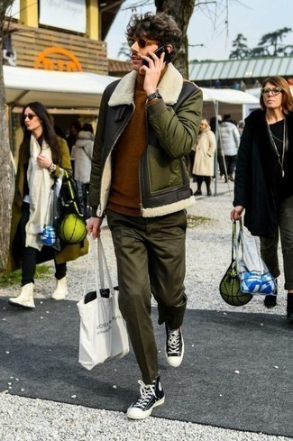 White Print Canvas Tote Bag Outfits For Men: An olive shearling jacket and a white print canvas tote bag are great menswear staples that will integrate brilliantly within your casual styling lineup. A nice pair of black and white canvas high top sneakers ties this look together.