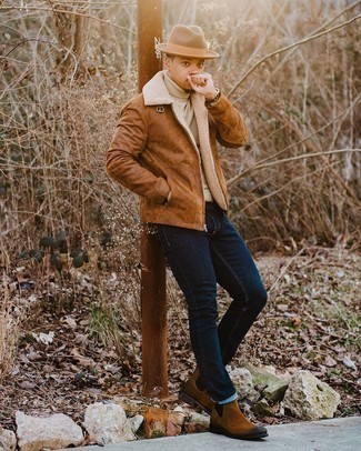 Brown Shearling Jacket Outfits For Men: A brown shearling jacket and navy jeans are a cool combo to add to your off-duty fashion mix. Flaunt your refined side by finishing with brown suede chelsea boots.