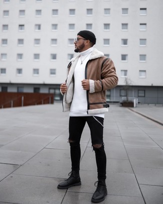 500+ Winter Outfits For Men: Dress in a brown shearling jacket and black ripped skinny jeans, if you feel like comfort dressing without looking like a hobo to look stylish. A pair of black leather casual boots easily revs up the wow factor of any ensemble. In winter, when warmth is the priority, it can be easy to settle for a less-than-stylish outfit in the name of practicality. But this outfit is a shining example that you can actually stay toasty and remain stylish at the same time in winter.
