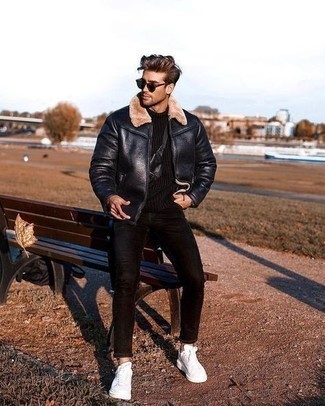 Black Knit Turtleneck Outfits For Men: Extremely stylish, this combo of a black knit turtleneck and black skinny jeans offers excellent styling possibilities. Add a pair of white canvas low top sneakers to the equation to change things up a bit.