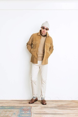 Beige Cable Sweater Outfits For Men: Dress in a beige cable sweater and white chinos for both dapper and easy-to-create getup. If you want to feel a bit fancier now, introduce brown leather loafers to the mix.