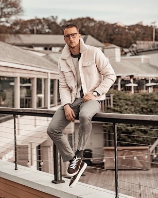 Dark Brown Suede Low Top Sneakers Outfits For Men: This combo of a beige shirt jacket and grey chinos can only be described as incredibly stylish and casually neat. Introduce a pair of dark brown suede low top sneakers to the equation to make a standard look feel suddenly edgier.