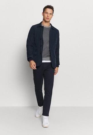 Navy Nylon Shirt Jacket Outfits For Men: Consider wearing a navy nylon shirt jacket and black chinos to don a sleek and classy ensemble. Introduce a mellow vibe to by wearing white canvas low top sneakers.