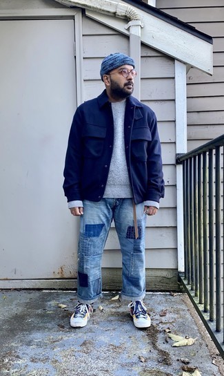 Light Blue Patchwork Jeans Outfits For Men: A navy shirt jacket and light blue patchwork jeans are absolute menswear staples that will integrate perfectly within your day-to-day repertoire. Multi colored canvas high top sneakers add a casual aesthetic to the outfit.