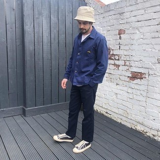 Bucket Hat Outfits For Men: If you put comfort above all else, this contemporary combination of a navy shirt jacket and a bucket hat is your go-to. With shoes, you can take the classic route with black and white canvas low top sneakers.