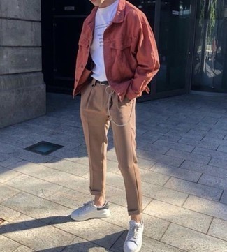 White and Black Leather Low Top Sneakers Outfits For Men: This combination of a red shirt jacket and khaki chinos is definitive proof that a straightforward outfit doesn't have to be boring. Why not rock a pair of white and black leather low top sneakers for a sense of stylish nonchalance?