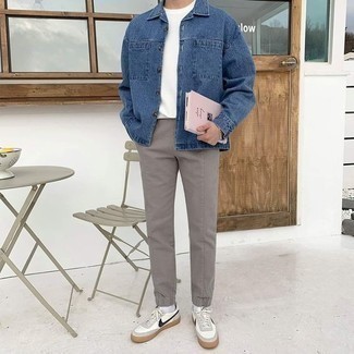 Navy Denim Shirt Jacket Outfits For Men: For an effortlessly sleek ensemble, marry a navy denim shirt jacket with grey chinos — these items play perfectly well together. Get a little creative on the shoe front and add white and navy leather low top sneakers to the equation.