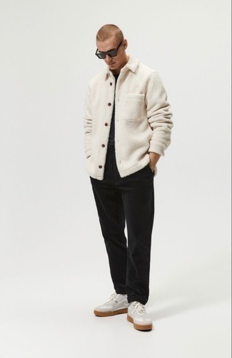 White Fleece Shirt Jacket Outfits For Men: Make a white fleece shirt jacket and black chinos your outfit choice to be the picture of rugged elegance. White leather low top sneakers can instantly tone down an all-too-polished ensemble.