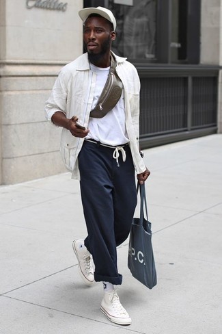 Olive Leather Fanny Pack Outfits For Men: A white shirt jacket and an olive leather fanny pack married together are the ideal look for those dressers who appreciate laid-back and cool ensembles. When not sure as to the footwear, stick to a pair of white canvas high top sneakers.