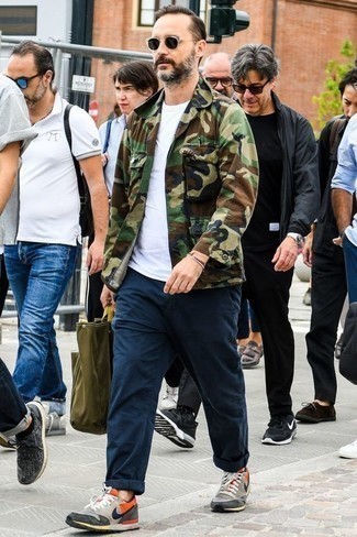 Olive Camouflage Shirt Jacket Outfits For Men: This casual pairing of an olive camouflage shirt jacket and navy chinos can take on different moods depending on how you style it. Feeling creative? Shake up this ensemble by rocking a pair of grey athletic shoes.