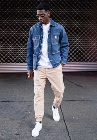 Blue Denim Shirt Jacket Outfits For Men: Kick up your style game in this combination of a blue denim shirt jacket and beige chinos. Let your styling expertise truly shine by finishing your outfit with white canvas low top sneakers.