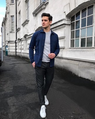 Grey Vertical Striped Chinos Outfits: This pairing of a navy shirt jacket and grey vertical striped chinos is the ultimate off-duty style for any modern guy. A pair of white canvas low top sneakers adds a more casual aesthetic to the outfit.