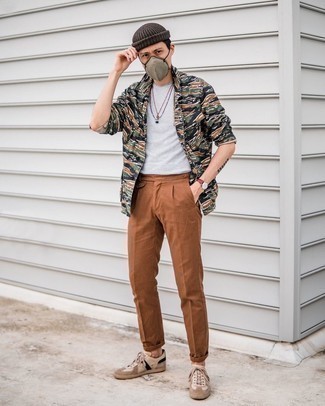Olive Camouflage Shirt Jacket Outfits For Men: For a casually cool getup, team an olive camouflage shirt jacket with brown chinos — these two pieces fit really well together. For a more relaxed aesthetic, introduce a pair of beige leather low top sneakers to the mix.