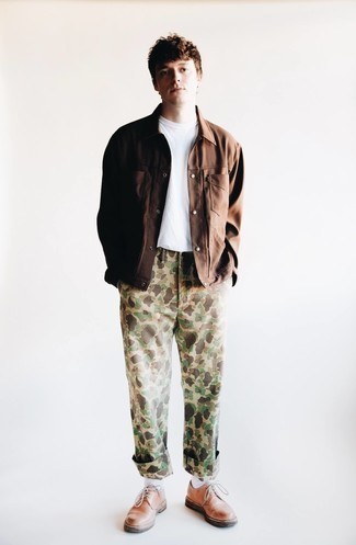 Khaki Camouflage Chinos Outfits: Look awesome without trying too hard by opting for a brown shirt jacket and khaki camouflage chinos. For a more polished feel, why not complement this getup with brown leather derby shoes?