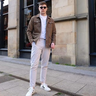 Brown Shirt Jacket Outfits For Men: For a look that's worthy of a modern sartorially savvy gent and effortlessly smart, consider wearing a brown shirt jacket and beige chinos. White and black leather low top sneakers are an effective way to infuse a dose of stylish effortlessness into your look.