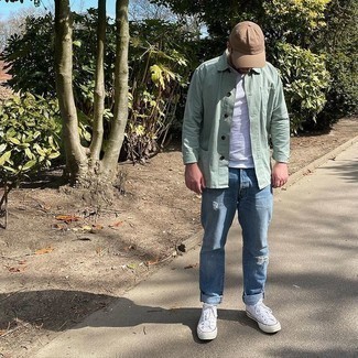 Light Blue Ripped Jeans Outfits For Men: Consider wearing a mint shirt jacket and light blue ripped jeans to pull together a seriously stylish and modern-looking casual ensemble. Complete this getup with white canvas low top sneakers and ta-da: the look is complete.