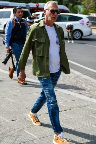 Blue Patchwork Jeans Outfits For Men: Extra stylish, this casual pairing of an olive shirt jacket and blue patchwork jeans brings excellent styling possibilities. If you need to easily play down this ensemble with one item, why not introduce tobacco canvas low top sneakers to the mix?