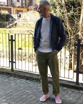 White Canvas Slip-on Sneakers Outfits For Men: This combination of a navy shirt jacket and olive chinos looks neat and makes you look instantly cooler. Feeling inventive? Switch up your outfit with white canvas slip-on sneakers.