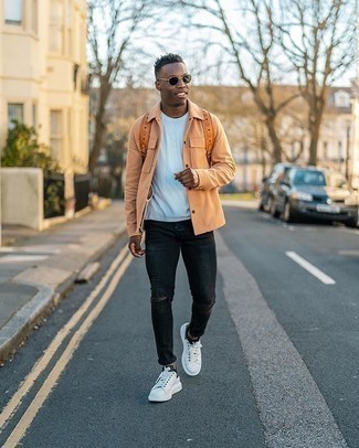 Orange Shirt Jacket Outfits For Men: Pair an orange shirt jacket with black ripped skinny jeans for equally stylish and easy-to-style ensemble. Complete this look with white and black canvas low top sneakers to completely shake up the getup.