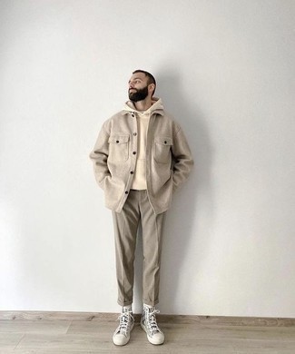 Beige Hoodie Outfits For Men: This combination of a beige hoodie and grey chinos is a safe go-to for a devastatingly stylish outfit. Rev up this whole outfit by slipping into grey print canvas high top sneakers.