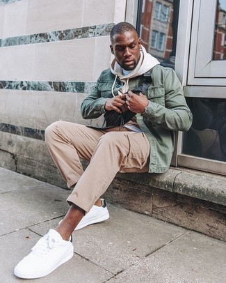Tan Hoodie Outfits For Men: Teaming a tan hoodie with khaki chinos is a great option for a relaxed yet on-trend look. A pair of white and black canvas low top sneakers is a wonderful pick to complete your look.