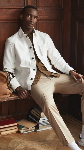 Tobacco Canvas Duffle Bag Outfits For Men: Reach for a white shirt jacket and a tobacco canvas duffle bag for a look that's both bold casual and dapper. White and black leather low top sneakers will immediately dress up even the most basic look.
