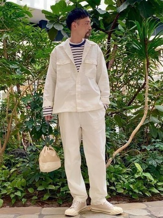 White Shirt Jacket Outfits For Men: Marry a white shirt jacket with white chinos to put together a sleek and sophisticated ensemble. Introduce a more laid-back spin to by finishing with a pair of beige canvas low top sneakers.