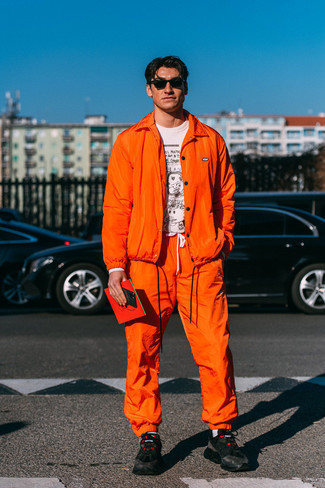 Orange Shirt Jacket Outfits For Men: This combo of an orange shirt jacket and orange sweatpants is the perfect base for an infinite number of stylish ensembles. Want to break out of the mold? Then why not add a pair of black athletic shoes to the mix?