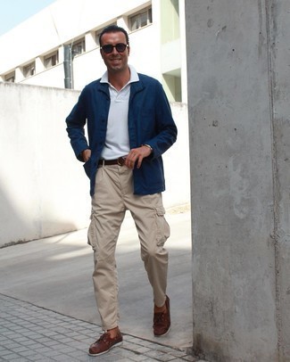 Beige Cargo Pants Outfits: Definitive proof that a navy shirt jacket and beige cargo pants are awesome when paired together in a laid-back ensemble. Brown leather boat shoes are a smart pick to round off this look.