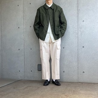 Men's Outfits 2021: This look with a dark green shirt jacket and beige cargo pants isn't hard to achieve and leaves room to more creative experimentation. You can get a bit experimental when it comes to footwear and throw a pair of black leather tassel loafers in the mix.