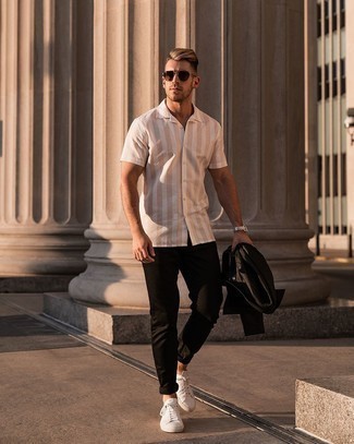 Black Chinos Outfits: Go for a black shirt jacket and black chinos and you'll exude rugged refinement and class. Finishing off with white canvas low top sneakers is a fail-safe way to inject a more laid-back vibe into your look.
