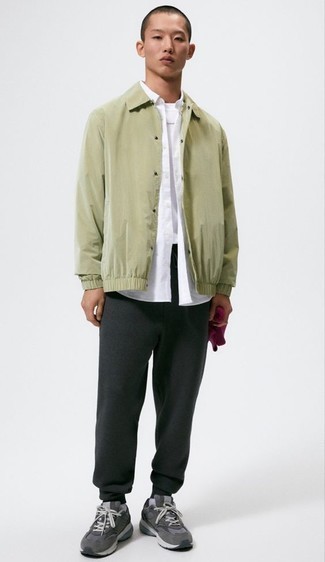 Olive Nylon Shirt Jacket Outfits For Men: Marry an olive nylon shirt jacket with charcoal sweatpants to create a daily look that's full of style and character. Balance out your ensemble with a more relaxed kind of footwear, such as this pair of charcoal athletic shoes.