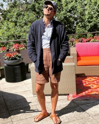 1200+ Relaxed Outfits For Men: A navy shirt jacket and brown linen shorts married together are a wonderful match. And if you want to immediately tone down your ensemble with shoes, complement your look with tobacco leather flip flops.