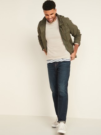 Beige Sweater Outfits For Men: The versatility of a beige sweater and navy jeans means they'll always be on heavy rotation in your menswear collection. Take a more sophisticated approach with shoes and introduce a pair of white canvas low top sneakers to your outfit.