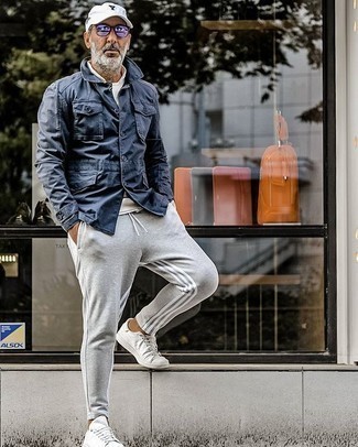 Charcoal Sweatshirt Outfits For Men: To achieve a laid-back outfit with an urban take, pair a charcoal sweatshirt with grey sweatpants. For maximum effect, complement your getup with white canvas low top sneakers.
