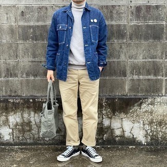 Men's Outfits 2021: This pairing of a navy denim shirt jacket and beige chinos is an interesting balance between dressy and casual. For something more on the daring side to complete your look, complement this getup with a pair of black and white canvas low top sneakers.