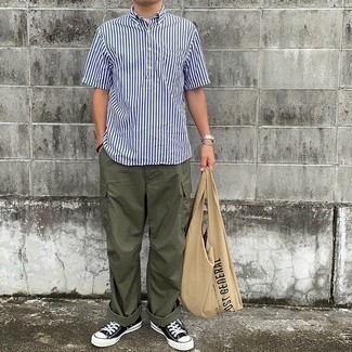 Tan Print Canvas Tote Bag Outfits For Men: Wear a white and navy vertical striped short sleeve shirt with a tan print canvas tote bag to put together an interesting and casual street style outfit. Make a bit more effort with shoes and choose a pair of black and white canvas low top sneakers.