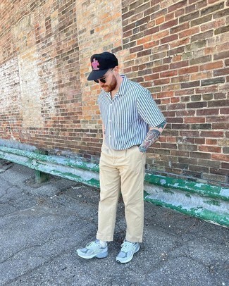 Navy Print Baseball Cap Outfits For Men: You'll be amazed at how easy it is for any man to put together a modern casual ensemble like this. Just a light blue vertical striped short sleeve shirt and a navy print baseball cap. Light blue athletic shoes are an easy way to breathe a touch of elegance into this ensemble.