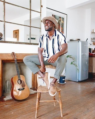 Tan Bucket Hat Outfits For Men: Wear a white and navy vertical striped short sleeve shirt and a tan bucket hat for a knockout and fashionable getup. Introduce tan leather derby shoes to the equation to completely shake up the look.