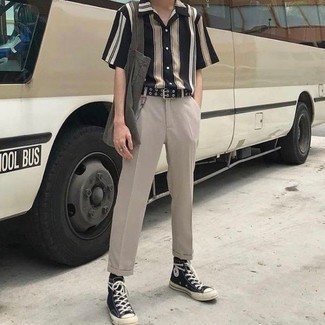 Black and White Vertical Striped Short Sleeve Shirt Outfits For Men: A black and white vertical striped short sleeve shirt and beige chinos married together are a great match. Put a more relaxed spin on this getup by sporting a pair of black and white canvas high top sneakers.