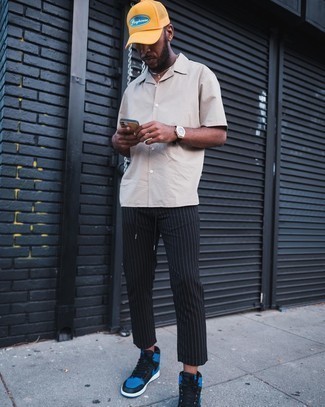 Beige Short Sleeve Shirt Outfits For Men: This look with a beige short sleeve shirt and black vertical striped chinos isn't so hard to achieve and is open to more experimentation. Take your ensemble down a more informal path by wearing black leather high top sneakers.