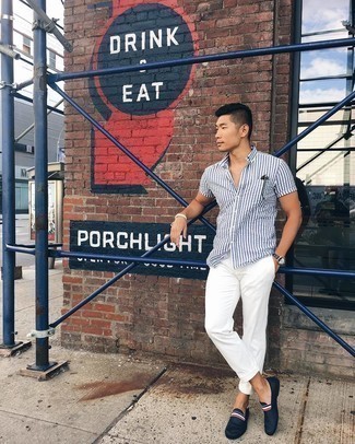 White and Navy Vertical Striped Short Sleeve Shirt Outfits For Men: To pull together a relaxed menswear style with a modern twist, marry a white and navy vertical striped short sleeve shirt with white chinos. Feeling inventive today? Dress up this getup by slipping into navy canvas loafers.