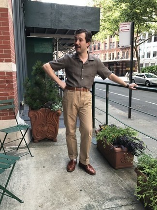 Dark Brown Short Sleeve Shirt Outfits For Men: This laid-back combo of a dark brown short sleeve shirt and khaki chinos is a lifesaver when you need to look good in a flash. Balance your ensemble with a classier kind of shoes, such as this pair of brown leather loafers.