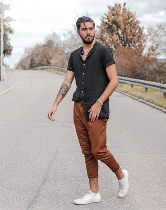 Charcoal Short Sleeve Shirt Outfits For Men: Who said you can't make a fashion statement with an off-duty ensemble? Draw the attention in a charcoal short sleeve shirt and tobacco chinos. Our favorite of a ton of ways to complete this getup is a pair of white canvas low top sneakers.